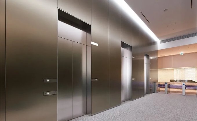 Used a brushed stainless steel sheets for modern wall cladding in lobby and elevator.